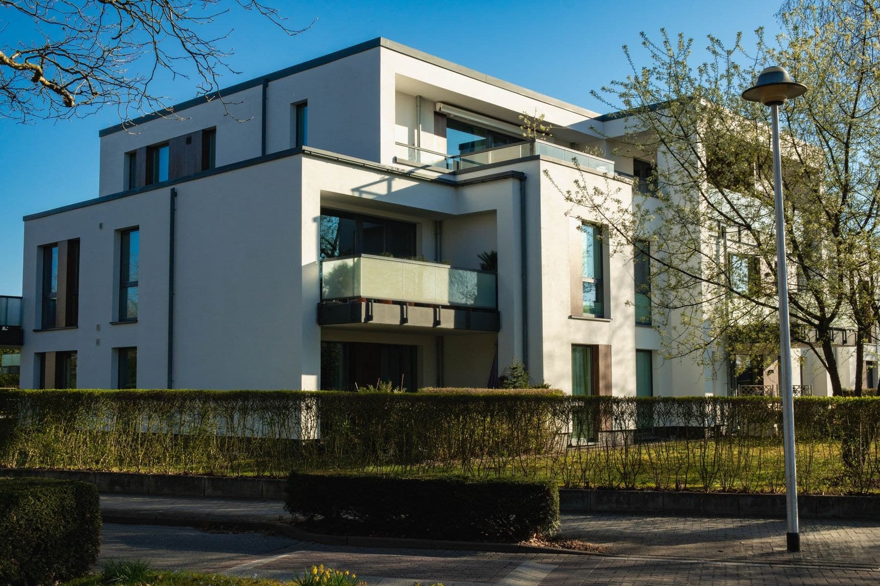 Residential apartment building with individual balconies and landscaped grounds